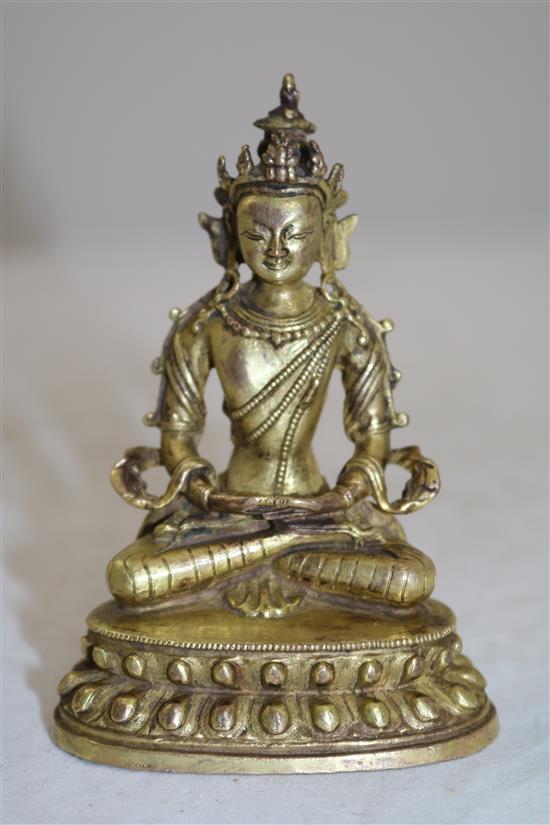 A small Tibetan gilt bronze seated figure of Amitayus, 18th/19th century, height 11cm